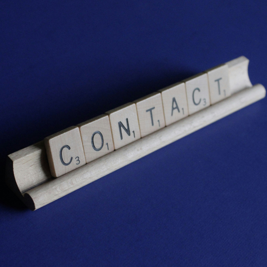 Dev Tech Solutions | an image showing the word contact on a scrabble board