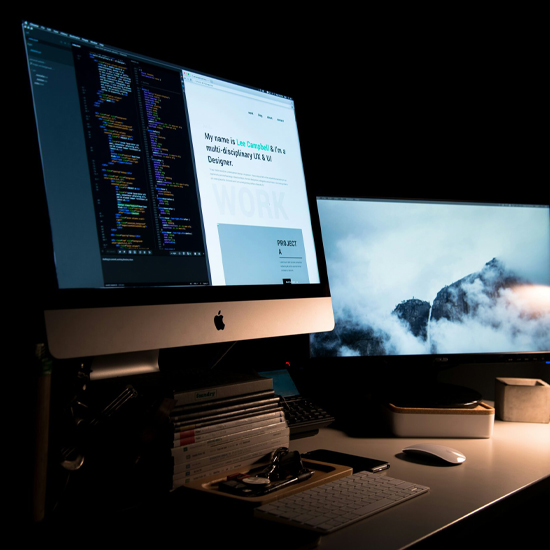 Dev Tech Solutions | A Mac with a website and code displayed on the screen
