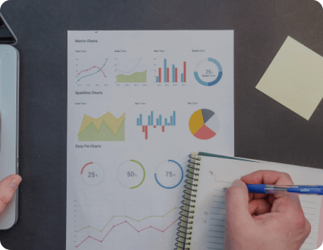 Dev Tech Solutions | Person reviewing simplified analytics charts and taking notes to understand website user behaviour.