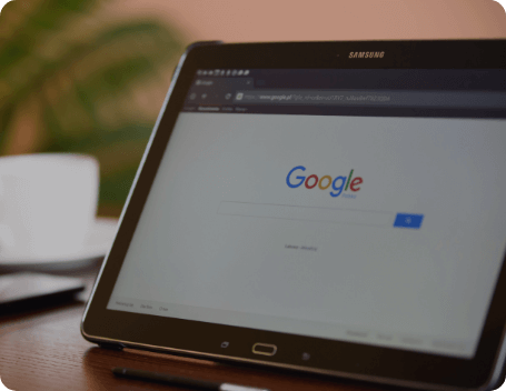 Dev Tech Solutions | Tablet displaying a Google search page on a desk, representing search visibility and on-page SEO fundamentals.