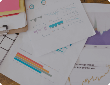 Dev Tech Solutions | Printed analytics charts and performance graphs spread across a desk during a website data review.