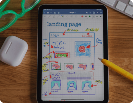 Dev Tech Solutions | Hand-drawn landing page wireframe displayed on a tablet, showing page layout, headings, and content sections.